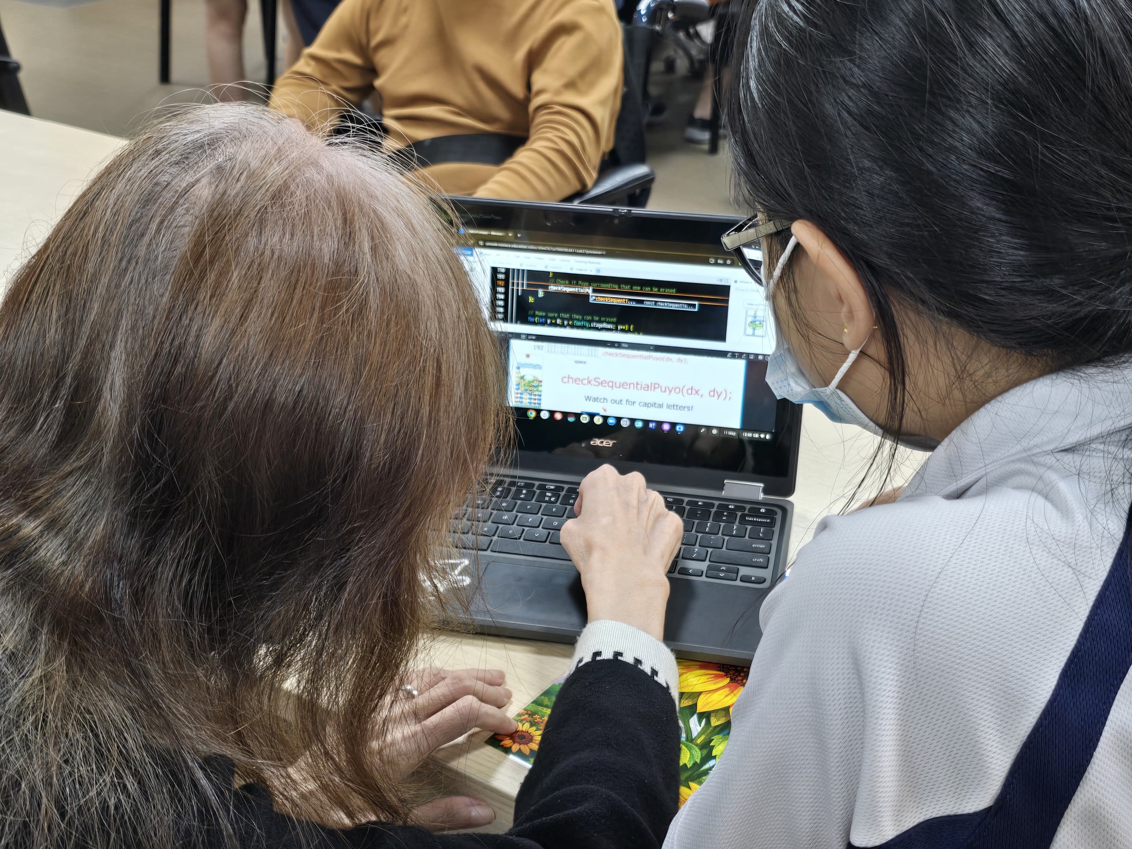 Singapore students and adult learners gathered around a GAKU classroom session